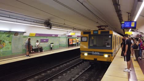 People-Wait-For-Subway-Arrival-at-Yellow-Train-Underground-Station-of-Line-E-Subte,-Jujuy