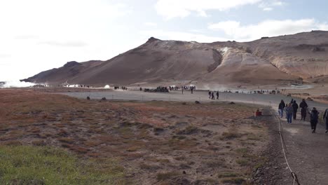 People-exploring-the-geothermal-area-of-Namafjall-Hverir-in-Iceland