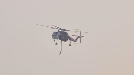 Helicopter-over-a-covered-Skyline-in-Alberta-Canada-monitoring-a-forest-fire-Spinning-its-Fins