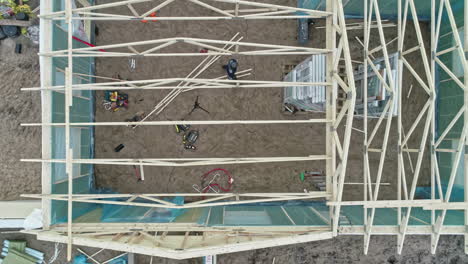 Aerial-top-down-shot-over-a-wooden-roof-frame-construction-of-a-detached-house