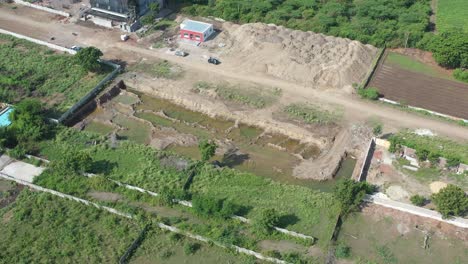 aerial-drone-shot-moving-towards-drone-side-and-lots-of-trees-and-fields-are-visible-and-there-is-a-road