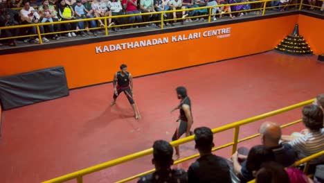 pov-shot-many-tourists-are-happy-watching-Lathi-Baji-and-are-also-shooting-on-phone-and-two-people-are-playing-Lathi-in-the-arena