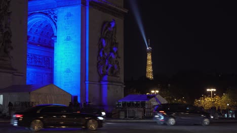 Arco-De-Triunfo-Y-Torre-Eiffel-Brillante-Iluminada-En-El-Mismo-Panorama-Nocturno-Con-Tráfico-En-El-Marco