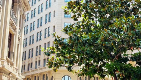 People-Walk-in-Warm-Summer-around-Barrio-La-Bolsa-Historic-Architectural-Center,-Ariztia-Building-Square-and-Skyline