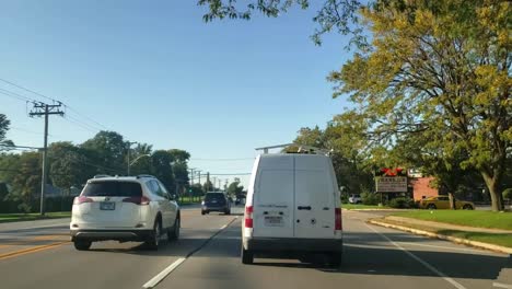 Driving-from-a-Menards-onto-a-main-street-in-the-summer,-time-lapse