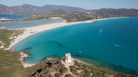 Drone-flight-over-a-bay-with-a-tower-in-the-foreground