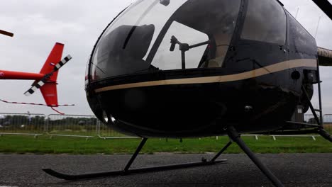 Different-color-Robinson-R22-helicopters-parked-in-line-at-aviation-airshow