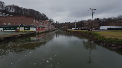 Old-brick-buildings-in-an-industrial-park-with-a-creek-in-small-town,-Wappingers-Falls,-USA