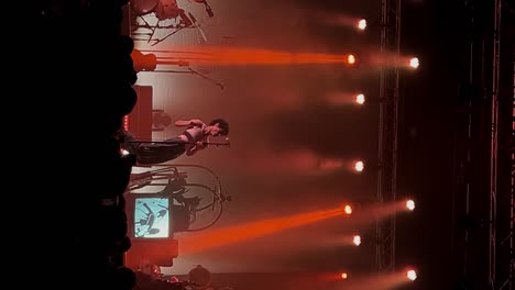 Vertical-handheld-medium-shot-of-Samuel-Holden-Jaffe-playing-singing-and-performing-live-in-concert-as-the-Del-Water-Gap-band-with-orange-stage-lighting-at-the-Complex-in-Salt-Lake-City-Utah