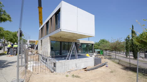 Vista-De-Movimiento-Del-Sitio-De-Construcción-De-Casas-Modulares-Y-Grúas-Pesadas