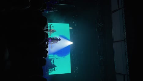 Vertical-wide-handheld-shot-of-Tyson-Ritter-and-the-All-American-Rejects-band-playing,-singing,-and-performing-live-in-concert-at-the-The-Great-Saltair-Amphitheater-in-Utah-with-flashing-lights