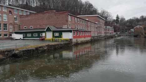 Old-brick-buildings-in-an-industrial-park-with-a-creek-in-small-town,-Wappingers-Falls,-USA