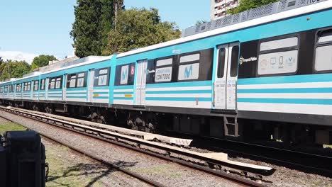 Train-Arrives-in-Slow-Motion-in-Countryside-Landscape-Sarmiento-Line-Railway