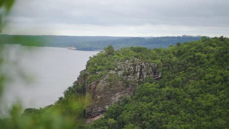 Wonderful-landscape-of-mountains,-hills-and-hills-full-of-trees-among-a-cloudy-sky-with-clouds-in-summer-over-the-sea-or-lake