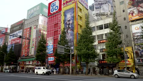 Traffic-Going-Past-Along-Main-Street-Road-In-Akihabara