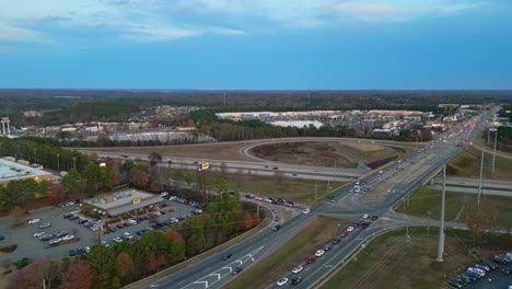 Aerial-flyover-road-and-highway-in-suburb-area-of-Cumming-City-during-cloudy-day-in-America---High-frequented-intersection