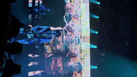 Vertical-close-up-handheld-shot-of-Tyson-Ritter-and-the-All-American-Rejects-band-playing,-singing,-and-performing-live-in-concert-at-the-The-Great-Saltair-Amphitheater-in-Utah-with-flashing-lights