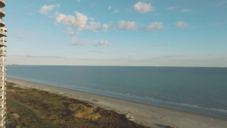 An-aerial-establishing-shot-of-Palisade-Palms-Luxury-Residential-Condominiums-overlooks-the-Gulf-of-Mexico-on-Galveston-Beach-in-Galveston,-Texas