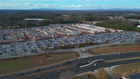 Seitliche-Luftaufnahme-Bei-Verkehr-Auf-Der-Autobahn-Und-Belebtem-Parkplatz-Im-Amerikanischen-Einkaufszentrum-Während-Der-Weihnachtszeit