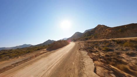 FPV-aerial-woman-galloping-through-a-desert-on-the-back-of-a-white-horse