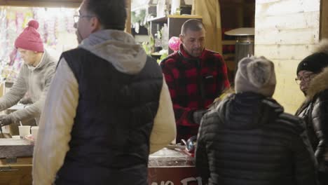 A-Man-Vending-Corn-at-a-Food-Stall-in-the-Park-as-Part-of-the-Galati-National-Day-Celebration-in-Romania---Medium-Shot