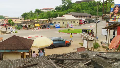 Street-traffic,-houses-and-green-hill-at-Cape-Coast-in-Ghana,-static