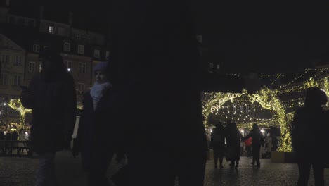 People-Walk-at-Old-Town-Market-Square-with-Christmas-Trees-Lighting-Decoration-in-Warsaw-Poland-during-at-Night