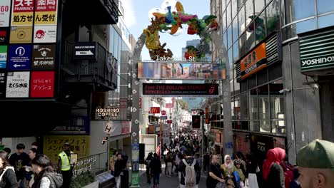 Takeshita-Street,-Harajuku,-pulses-with-energy-as-people-traverse-the-narrow-lane