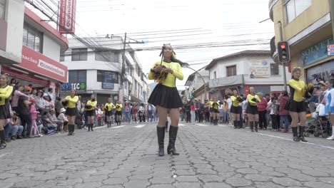 Majorettes-twirl-batons-black-yellow-outfits-town-festival-cultural-parade