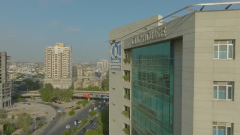 Aerial-paralapse-topshot-of-a-busy-street-beside-CDC-Buidling-during-daytime-in-Karachi,-Pakistan