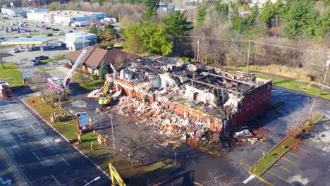 An-Excavator-Works-at-Environmental-Forest-Fire-Destroyed-Building-Aerial-Drone-Shot