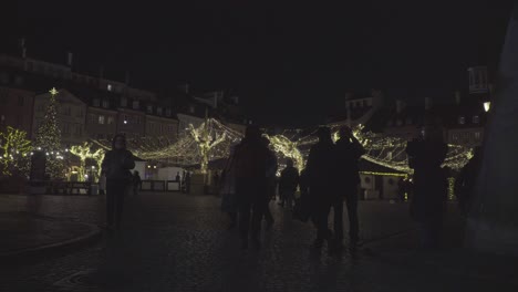 People-Walk-at-Old-Town-Market-Square-with-Christmas-Trees-Lighting-Decoration-in-Warsaw-Poland-during-Night