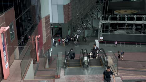 Slow-motion-shot-of-people-walking-around-and-riding-escalators-in-Kyoto-Station-in-Japan