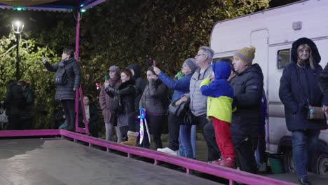 People-Recording-Videos-of-a-Bumpy-Car-Ride-in-the-Park-on-Galati-National-Day-in-Romania---Wide-Shot