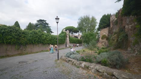 Rome-Immersive-POV:-Moving-In-Busy-Streets-to-Chiesa-Santi-Luca-e-Martina,-Italy,-Europe,-Walking,-Shaky,-4K-|-Reversing-From-Gate-Towards-Road