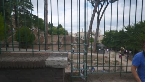 Rome-Immersive-POV:-Moving-In-Busy-Streets-to-Chiesa-Santi-Luca-e-Martina,-Italy,-Europe,-Walking,-Shaky,-4K-|-Tourists-Sitting-To-Take-A-Rest