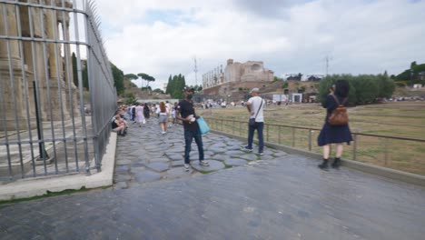 Rome-Immersive-POV:-Moving-In-Busy-Streets-to-Chiesa-Santi-Luca-e-Martina,-Italy,-Europe,-Walking,-Shaky,-4K-|-Tourists-and-Vendors-Selling-Products