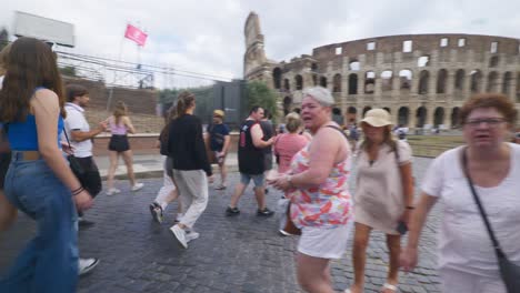 Rome-Immersive-POV:-Moving-In-Busy-Streets-to-Chiesa-Santi-Luca-e-Martina,-Italy,-Europe,-Walking,-Shaky,-4K-|-Large-Tourist-Group-Walking-Near-Colosseum