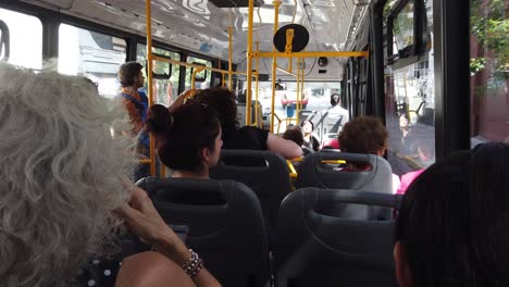 People-Travel-inside-Public-Autobus-Window-Bus-in-Latin-American-city-at-Summer