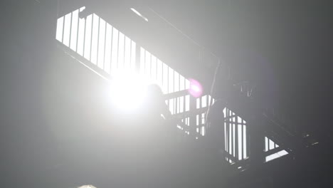 Silhouette-of-people-walking-on-elevated-subway-staircase-with-light-effect