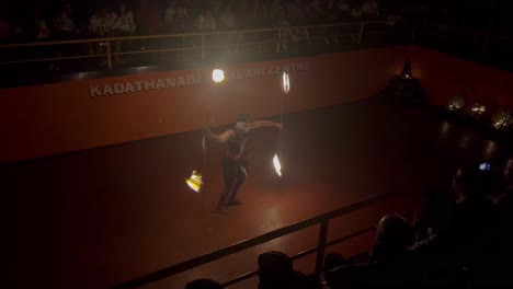 pov-shot-Many-tourists-are-looking-at-you-as-one-person-swings-sticks-in-the-arena