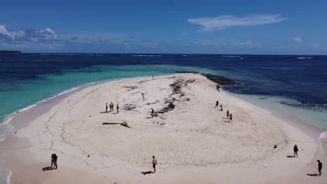 Two-tour-boats-at-naked-island-with-Island-hopping-tourists-enjoying-sunny-white-sand-beach-and-blue-clear-water