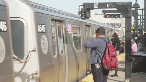 Commuters-getting-in-and-out-Train-at-elevated-subway-platform