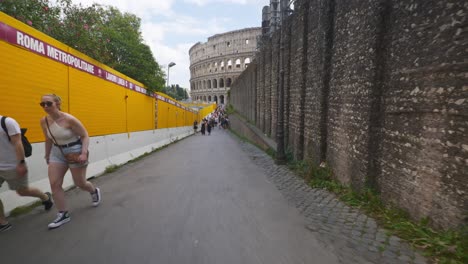 Rome-Immersive-POV:-Moving-In-Busy-Streets-to-Chiesa-Santi-Luca-e-Martina,-Italy,-Europe,-Walking,-Shaky,-4K-|-Couple-Walking-Path-Near-Colosseum