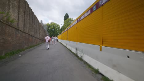 Rome-Immersive-POV:-Moving-In-Busy-Streets-to-Chiesa-Santi-Luca-e-Martina,-Italy,-Europe,-Walking,-Shaky,-4K-|-Bodybuilder-Woman-on-Small-Path