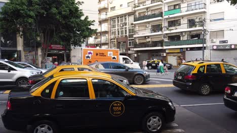 Los-Taxis-Negros-Y-Amarillos-Esperan-En-El-Semáforo-Bajo-La-Avenida-De-Luz-Diurna