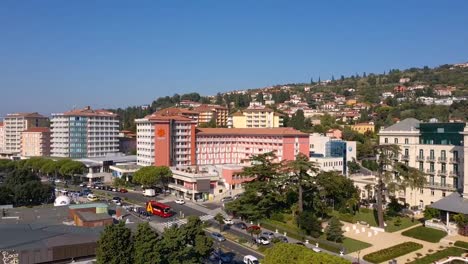 Backwards-left-pan-flying-drone-aerial-reveal-of-Trieste-shore-Barcolana-event,-Italy