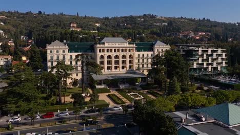 Backwards-ascending-drone-aerial-reveal-of-Trieste-shore-Barcolana-event,-Italy