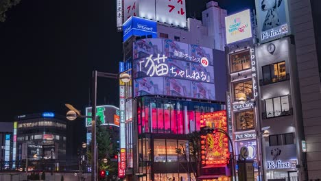 Night-Time-Lapse-of-Traffic-and-Crowds-of-People-Walking-at-the-3D-LED-screen-billboard-featuring-the-internet-famous-Shinjuku-cat-in-downtown-Shinjuku-Tokyo,-Japan-TILT