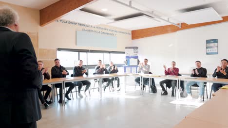 Businessman-ending-training-class,-young-male-students-clapping-hands-in-classroom